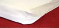 A close-up of a white cloth on a red surface.