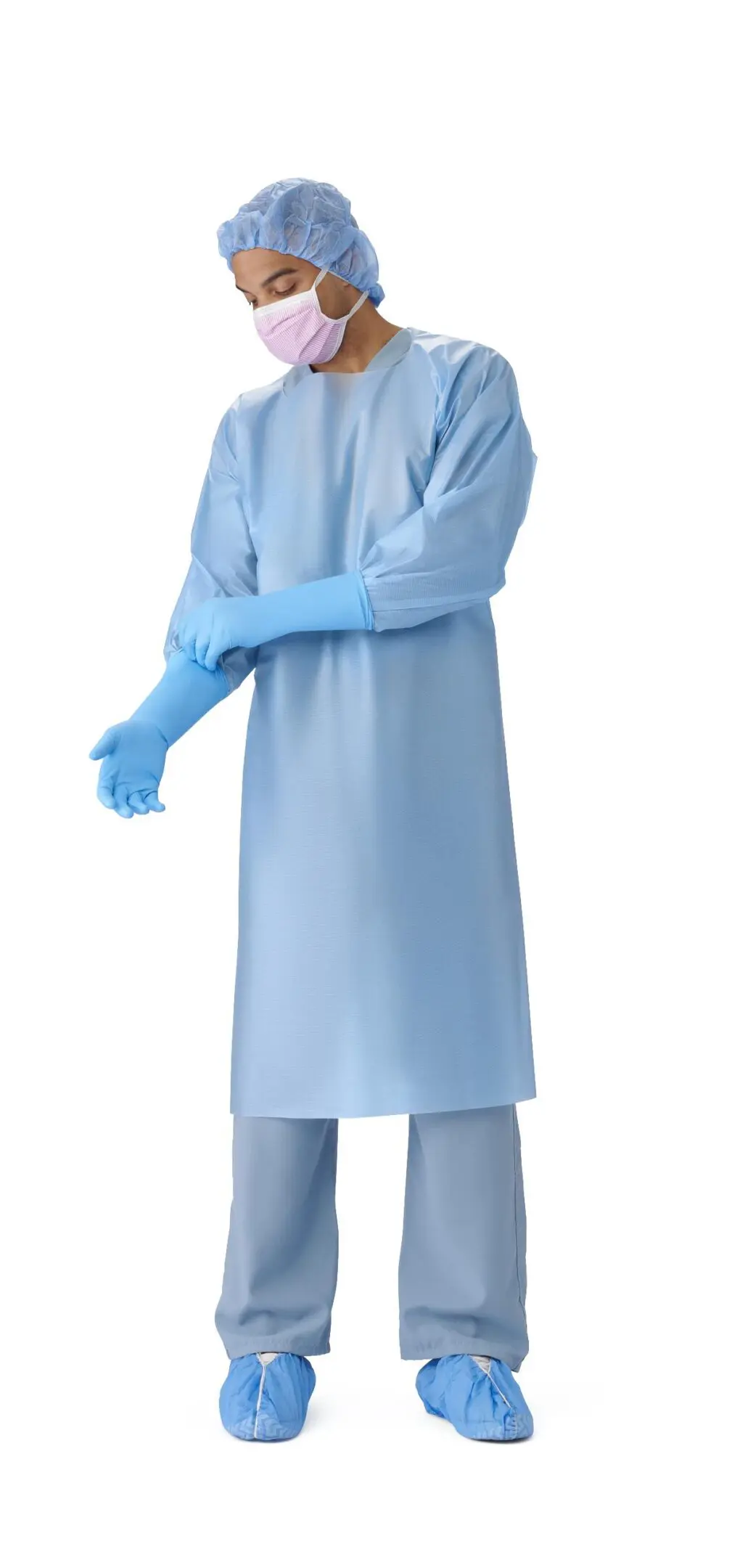 Medical professional wearing blue protective gown and gloves.