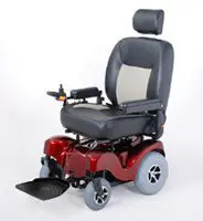 A red motorized wheelchair with a cushioned seat and footrest.