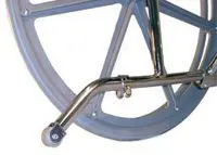 Close-up of a wheelchair wheel and footrest.
