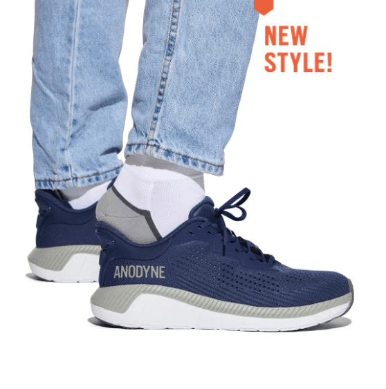 Modern navy blue sneakers paired with casual jeans and white socks.
