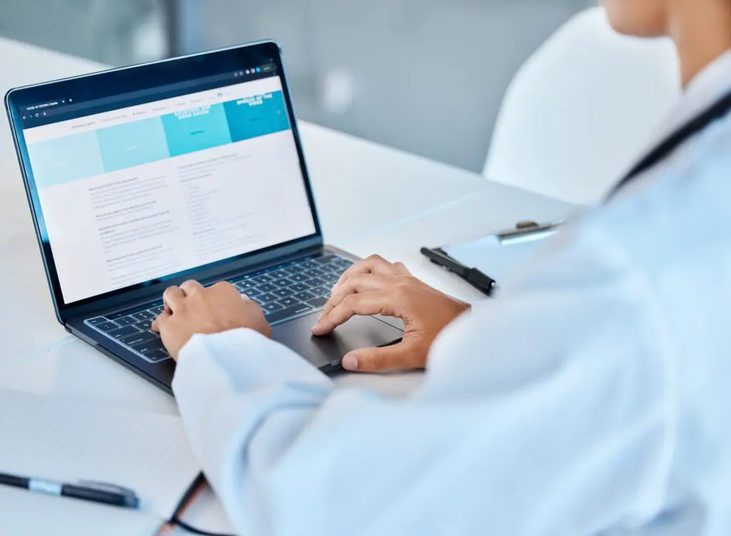 Laptop, medical and healthcare with a doctor working online in an office in the hospital for medicine and insurance. Research, analysis and treatment with a female health worker at work in a clinic