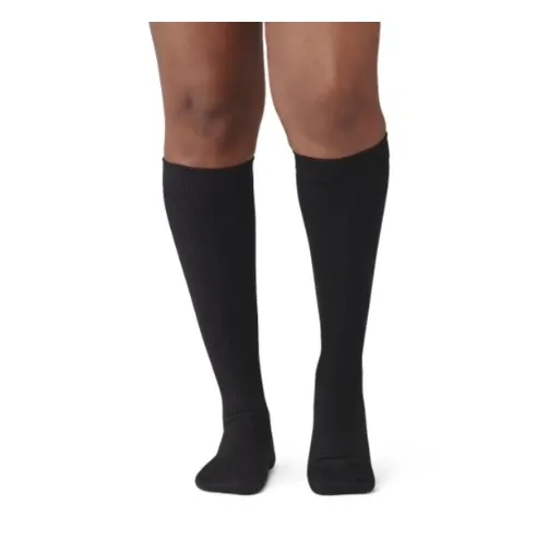 Person wearing black knee-high socks standing on a white background.