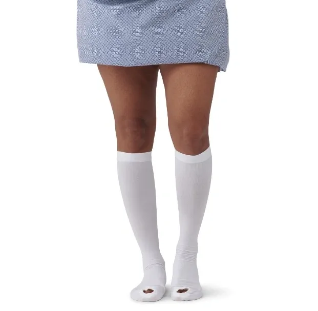Person wearing white knee-high socks and a blue skirt.