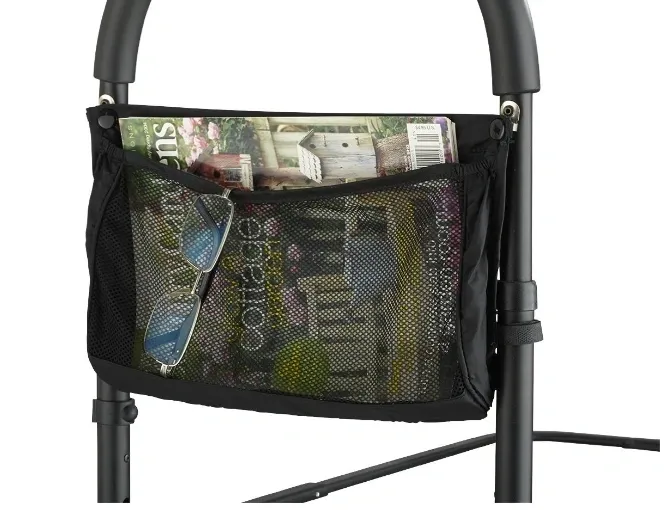 Black storage bag attached to walker with magazines inside.