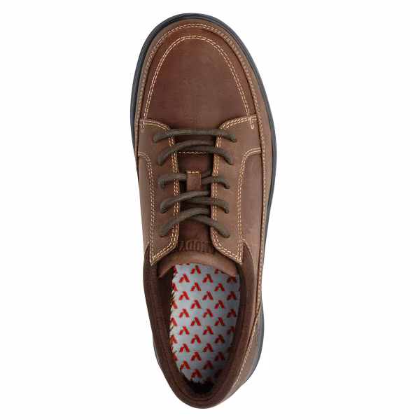 Top view of a brown leather shoe with laces and patterned insole.