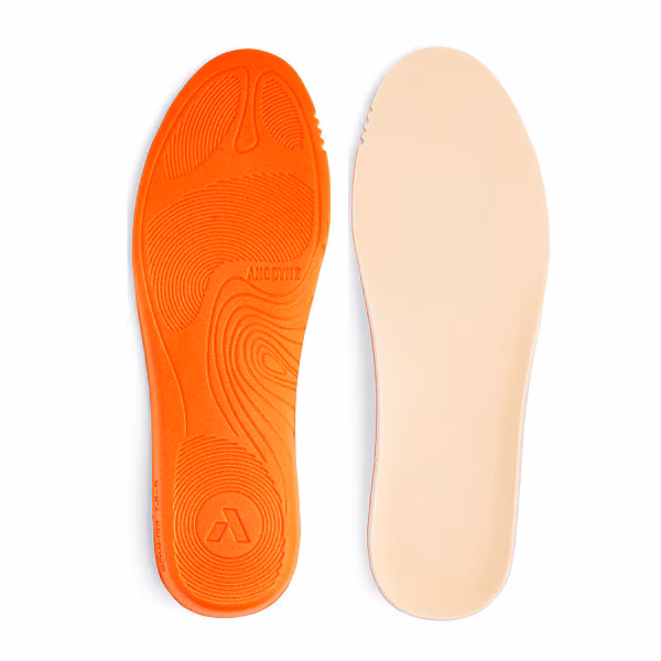 Pair of orange and beige shoe insoles with textured surfaces.